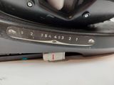 a close up of a black and silver electric iron on a white table