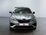 the front of a grey car in a showroom