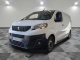la camionnette blanche est garée dans une grande pièce au sol en damier