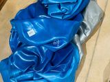 a blue blanket on the floor next to a pair of shoes