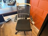 a chair that is sitting in front of a computer desk