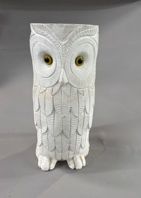 a white owl figurine sitting on a table