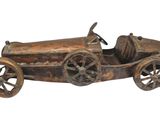 a wooden toy car with wheels on a white background