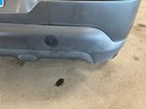 the rear bumper of a car with a sticker on it ' s bumper
