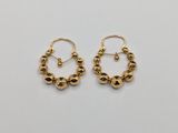a pair of gold earrings on a white background