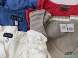 a pile of clothing on a table with a price tag on it