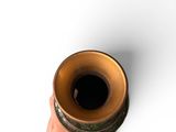 a hand that is holding a cup on a white surface