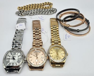 several watches and bracelets are sitting on a white surface
