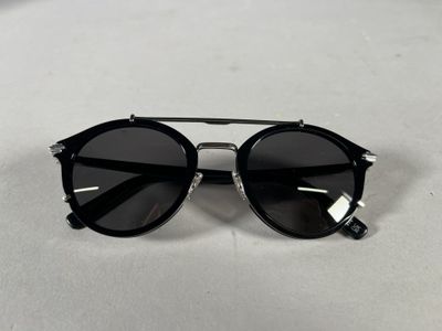 a close up of a pair of sunglasses on a white surface