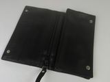a black leather wallet with a zipper on the inside