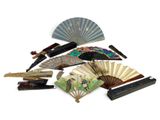 many different types of fan and other items on the table