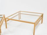 pair of glass and wood coffee tables on a white background