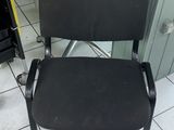 a black chair that is sitting on a tiled floor