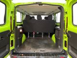a green van with a black seat in the back of it