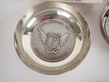 a silver plate with a silver medal on top of it
