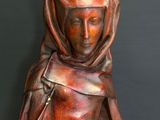 statue of a woman with a hood on her head and a scarf around her neck