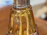 a bottle of perfume sitting on top of a wooden table