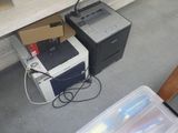 a printer sitting on the floor next to a printer