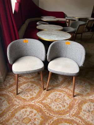 two chairs and a table in the corner of a room