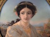 painting of a woman with a flower in her hair in a gold frame