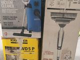 two boxes of vacuum cleaners sitting on the ground next to each other