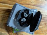 an image of a pair of earphones sitting on top of a wooden table