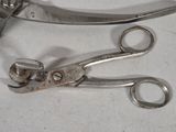two pairs of scissors sitting on a white surface