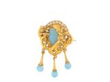 a close up of a gold and turquoise broochle broochle