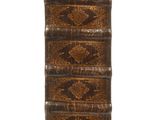 a close up of a stack of books on a white surface