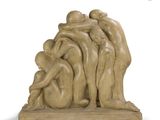 sculpture of a group of people hugging each other on a wooden base