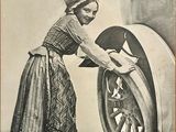 a woman that is washing a tire with a rag
