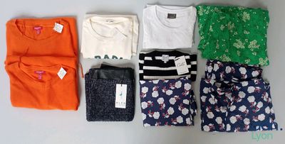 many different types of clothing laid out on the table