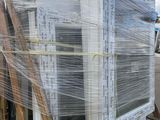 a large stack of windows wrapped in plastic on a pallet