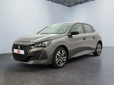 Une voiture grise est garée dans une grande pièce au sol noir.