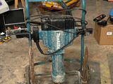 a blue machine that is sitting in a garage