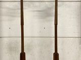pair of antique wooden coat stands with coat hooks on them