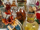 many bottles of different colors and sizes on a table