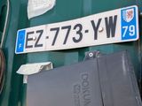 a green semi truck with a license plate on it
