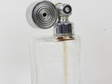 une petite bouteille en verre contenant un briquet