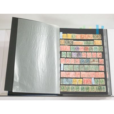 an open book with stamps on the pages and a sheet of paper