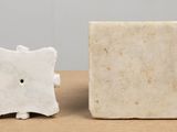 a small white object sitting next to a smaller white object
