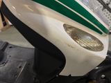 a close up of a motorcycle with a green and white stripe