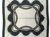 a black and white square scarf with pearls on it