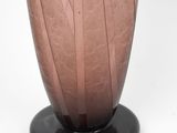 a pink vase with a black base on a white background