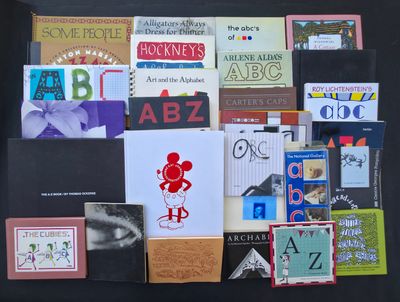 many books on a black table with a black background