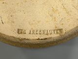 a close up of a vase with a label on it