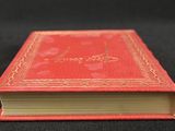 an open red book sitting on top of a black table