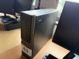 a desktop computer sitting on a desk in front of two monitors