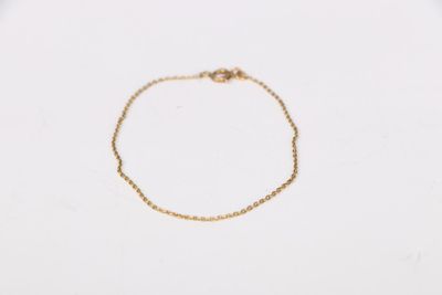 a gold chain bracelet with a tiny heart on it