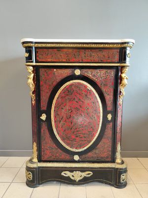 a red and black cabinet sitting on a tiled floor